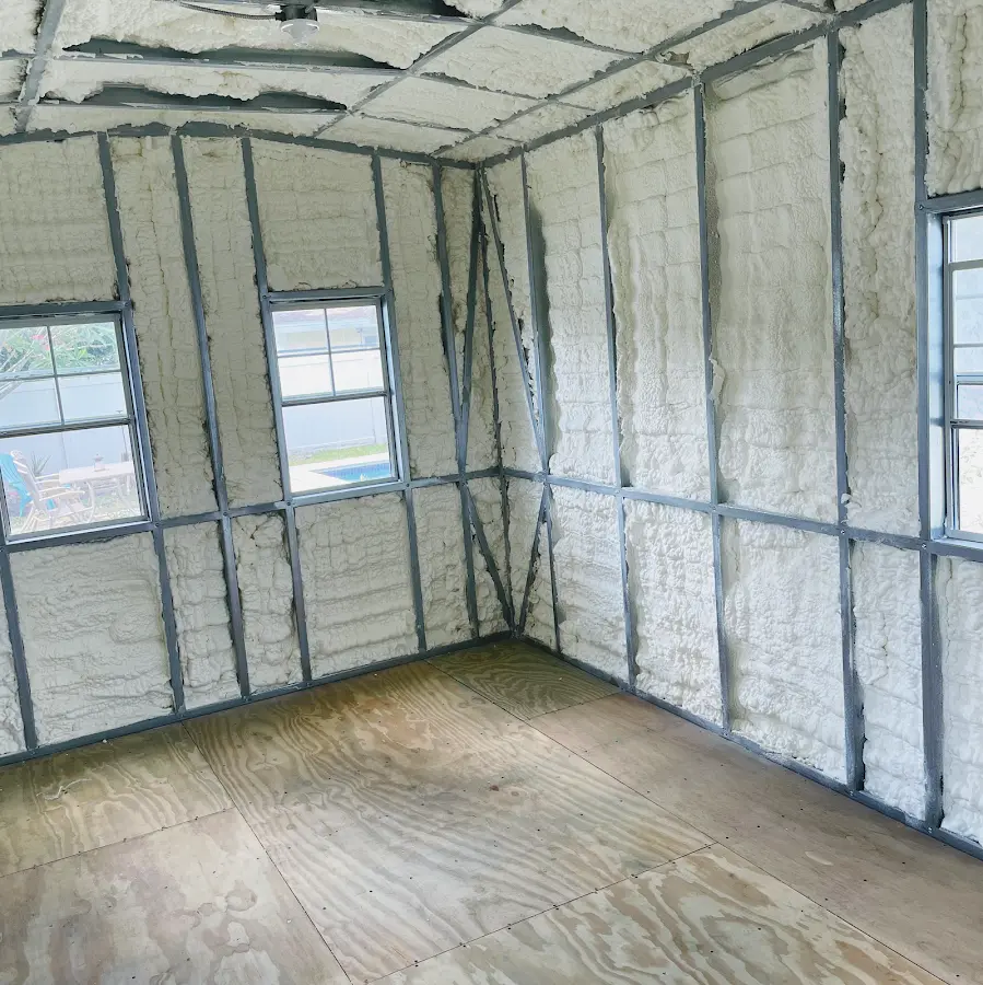 Closed-cell spray foam insulation applied to wall cavities in a residential project in Corrales
